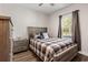 Comfortable bedroom showcasing a wood-framed bed, matching nightstands, and a sunlit window at 609 Mccown Dr., Conway, SC 29526