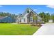 Well-maintained single-Gathering home featuring stone accents, white siding, and a spacious lawn at 609 Mccown Dr., Conway, SC 29526