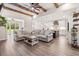 Bright and spacious living area with beamed ceilings, hardwood floors, and open kitchen layout at 609 Mccown Dr., Conway, SC 29526
