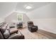 Comfortable living room area with a large leather couch, recliner, and a work space with a window at 609 Mccown Dr., Conway, SC 29526