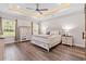 Spacious main bedroom with wood floors, tray ceilings, and large windows at 609 Mccown Dr., Conway, SC 29526