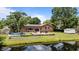 Backyard of a brick house with a patio, canal waterfront and lush green space at 6204 Sancindy Ln., Myrtle Beach, SC 29572