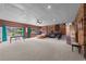 Large basement with carpet flooring and brick accent wall, great for entertaining at 6204 Sancindy Ln., Myrtle Beach, SC 29572