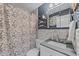 Charming bathroom featuring a floral shower curtain, tiled walls, and vanity with a gray countertop at 6204 Sancindy Ln., Myrtle Beach, SC 29572