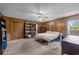 Bedroom with paneled walls, bookshelves and a ceiling fan for a relaxing ambiance at 6204 Sancindy Ln., Myrtle Beach, SC 29572