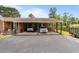 Wide view of the brick two car carport, with a picnic table, and lush green surrounding yard at 6204 Sancindy Ln., Myrtle Beach, SC 29572