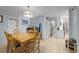 Open dining room adjacent to the Kitchen with natural light and blue paneled walls at 6204 Sancindy Ln., Myrtle Beach, SC 29572