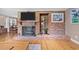 Close up view of the large brick fireplace with wooden mantel, and hearth at 6204 Sancindy Ln., Myrtle Beach, SC 29572