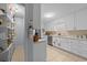 Well-lit kitchen with white cabinets, tiled floor and modern stainless steel appliances at 6204 Sancindy Ln., Myrtle Beach, SC 29572