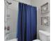 Bathroom featuring shower with blue curtain, toilet, and decorative seashell accents at 6253 Catalina Dr. # 1711, North Myrtle Beach, SC 29582