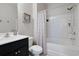 Clean bathroom featuring a shower-tub combo, white tiles, and black vanity at 6253 Catalina Dr. # 1711, North Myrtle Beach, SC 29582
