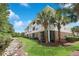 Beautiful condo building with lush landscaping, palm trees, and a tranquil creek at 6253 Catalina Dr. # 1711, North Myrtle Beach, SC 29582
