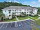 A multi-story condominium with meticulous landscaping, a visible parking lot, and charming balconies offers comfortable and convenient living at 6253 Catalina Dr. # 1711, North Myrtle Beach, SC 29582