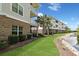 Attractive condominium building surrounded by beautiful landscaping, palm trees and a pond at 6253 Catalina Dr. # 1711, North Myrtle Beach, SC 29582
