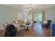 Bright and airy living room with wood floors, comfortable seating, and a view of the outdoor patio at 6253 Catalina Dr. # 1711, North Myrtle Beach, SC 29582