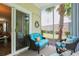 Comfortable seating is available on a relaxing screened-in patio with palm trees and sliding glass door at 6253 Catalina Dr. # 1711, North Myrtle Beach, SC 29582