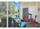 Inviting screened-in patio with exercise bike, garden views, and comfortable chair with colorful pillows at 6253 Catalina Dr. # 1711, North Myrtle Beach, SC 29582