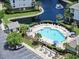 Aerial view of community pool area, featuring lounge chairs, picnic tables, water feature, landscaping, and building at 6253 Catalina Dr. # 1711, North Myrtle Beach, SC 29582
