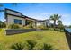 Spacious backyard with lush green lawn, featuring well-maintained landscaping and water view at 6706 Ocean Breeze Loop, Myrtle Beach, SC 29572