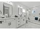 Luxurious bathroom featuring dual vanities, marble accents, a freestanding tub, and a walk-in shower at 6706 Ocean Breeze Loop, Myrtle Beach, SC 29572