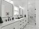 Bright bathroom featuring dual sinks, vanity and a glass enclosed shower with marble tile at 6706 Ocean Breeze Loop, Myrtle Beach, SC 29572