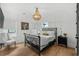 Charming bedroom with a decorative chandelier, a wrought iron bed frame, and an accent chair at 6706 Ocean Breeze Loop, Myrtle Beach, SC 29572