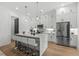 Modern kitchen with stainless steel appliances, a marble island with seating, and stylish pendant lighting at 6706 Ocean Breeze Loop, Myrtle Beach, SC 29572