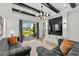 Comfortable living room features a dark accent wall, modern chandelier, and sliding doors to the patio at 6706 Ocean Breeze Loop, Myrtle Beach, SC 29572
