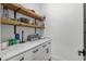 Well-organized pantry with wooden shelves, white cabinets, and marble countertops for ample storage at 6706 Ocean Breeze Loop, Myrtle Beach, SC 29572