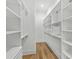 Bright walk-in closet with custom shelving, ample storage, and wood flooring offers style and functionality at 6706 Ocean Breeze Loop, Myrtle Beach, SC 29572