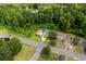 An aerial view of the property highlighting the home's location, spacious yard, and surrounding trees at 709 Highway 90, Conway, SC 29526
