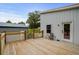 Large wooden back porch of white home is perfect for outdoor enjoyment at 709 Highway 90, Conway, SC 29526