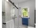Sleek bathroom with a glass-enclosed shower, mosaic tile accent, and natural light from the window at 709 Highway 90, Conway, SC 29526