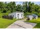 Exterior view of white building and metal shed surrounded by trees at 709 Highway 90, Conway, SC 29526