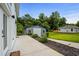 View of exterior shed surrounded by green lawn and walkway at 709 Highway 90, Conway, SC 29526