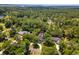 An aerial view shows a beautiful home nestled among lush, green trees in a serene setting at 77 Capt Anthony White Ln., Georgetown, SC 29440