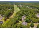 An aerial view shows a golf course winding through a neighborhood of beautiful homes at 77 Capt Anthony White Ln., Georgetown, SC 29440