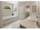 Serene bathroom offers a soaking tub, double vanities, and bright, natural light at 77 Capt Anthony White Ln., Georgetown, SC 29440