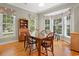Cozy dining room boasts natural light, a bay window, and a classic wooden dining set at 77 Capt Anthony White Ln., Georgetown, SC 29440