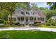 Charming home with a welcoming front porch, manicured landscaping, and a long driveway at 77 Capt Anthony White Ln., Georgetown, SC 29440