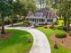 An inviting two-story home features a charming porch and landscaped yard at 77 Capt Anthony White Ln., Georgetown, SC 29440