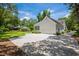 Well-maintained home exterior with a garage, driveway, and mature trees at 77 Capt Anthony White Ln., Georgetown, SC 29440