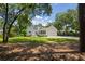 Beautiful home exterior with a well-manicured lawn, garage, and inviting backyard at 77 Capt Anthony White Ln., Georgetown, SC 29440