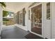 Cozy front porch featuring a hanging swing, wreath on the front door, and warm lighting fixture at 77 Capt Anthony White Ln., Georgetown, SC 29440