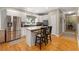 Bright kitchen features stainless steel appliances, a breakfast bar with seating, and hardwood flooring at 77 Capt Anthony White Ln., Georgetown, SC 29440