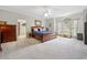 Inviting bedroom with a king-size bed, walk-in closet, and arched windows for natural light at 77 Capt Anthony White Ln., Georgetown, SC 29440