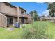 The backyard featuring grassy area, privacy fence, air conditioner, and view of nearby building at 800 Egret Circle # 53, Little River, SC 29566