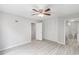 A bright bedroom featuring an ensuite bathroom, closet, neutral walls, and modern flooring at 800 Egret Circle # 53, Little River, SC 29566