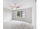 A bedroom featuring neutral walls, a ceiling fan, and a large window offering serene outdoor views at 800 Egret Circle # 53, Little River, SC 29566
