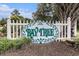 Community sign at Bay Tree neighborhood on white picket fence with green foliage accents at 800 Egret Circle # 53, Little River, SC 29566